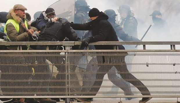 This picture taken on January 5 shows Dettinger during clashes with French Gendarmes as part of a demonstration by the u2018yellow vestsu2019 movement, on the passerelle Leopold-Sedar-Senghor bridge in Paris.