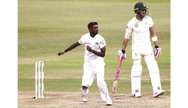Sri Lankau2019s Lasith Embuldeniya (left) bowls as South Africau2019s Faf du Plessis looks on during the 3rd day of the first Test at Kingsmead Cricket Ground in Durban yesterday. (AFP)