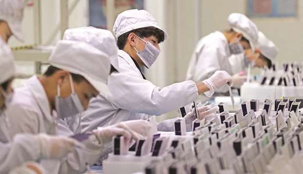 Workers are seen at a production line manufacturing solar photovoltaic components at a factory in Huzhou, Zhejiang province. Chinau2019s producer price index in January rose a meagre 0.1% from a year earlier, data from the National Bureau of Statistics showed yesterday.
