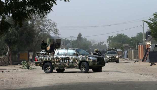 Nigerian military secure the area where a man was killed by suspected militants during an attack around Polo area of Maiduguri, Nigeria