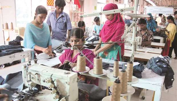 Employees work at a garment factory in Dhaka. More than 11,000 workers have been fired after recent labour protests, according to one labour union, as Bangladeshu2019s ready-made garment sector faces a renewed bout of labour turmoil.