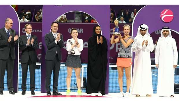 Belgium's Elise Mertens poses with the trophy alongside HE Sheikha Hind bint Hamad al-Thani, vice-chairperson and CEO of Qatar Foundation, Paris St Germain president Nasser Al-Khelaifi and runner-up Romania's Simona Halep