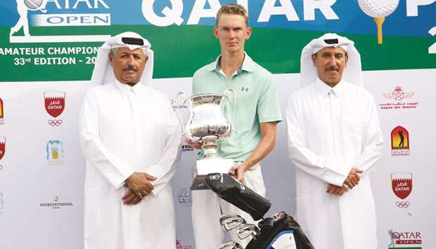 Mikkel Mathiesen (centre) poses with his trophy and Qatar Golf Association general secretary Fahad al-Naimi (left) and board member Mohamed Faisal al-Naimi after winning the Qatar Open Amateur Golf Championship yesterday. PICTURES: Jayaram