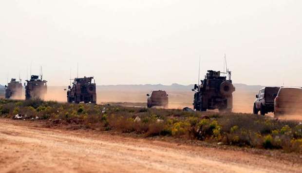 A military convoy with the US-backed Syrian Democratic Forces (SDF) is seen during an operation to expel Islamic State group (IS) jihadists in the countryside of the eastern Syrian province of Deir Ezzor