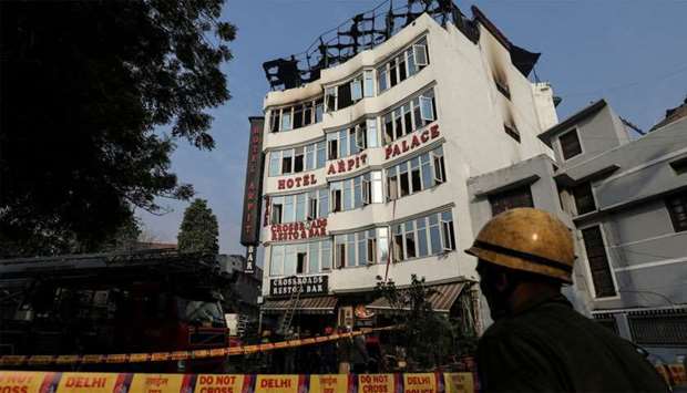 A fireman stands outside the hotel where a fire broke out in New Delhi
