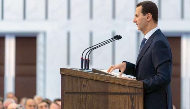 President Bashar al-Assad delivering a speech at a meeting for the heads of local councils in the capital Damscus. AFP/Syrian Presidency Facebook page.
