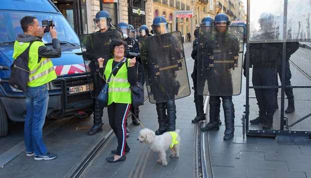 French gendarmes face protesters during a yellow vest (gilets jaunes) anti-government demonstration yesterday.