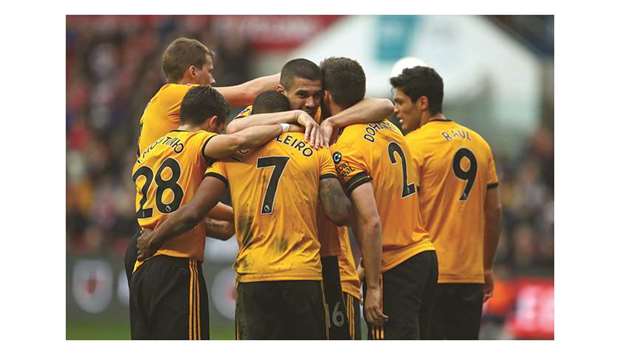 Wolverhampton Wanderersu2019 Portuguese midfielder Ivan Cavaleiro (No 7) celebrates with teammates after scoring the opening goal of the English FA Cup fifth round match against Bristol City at Ashton Gate Stadium in Bristol yesterday. (AFP)