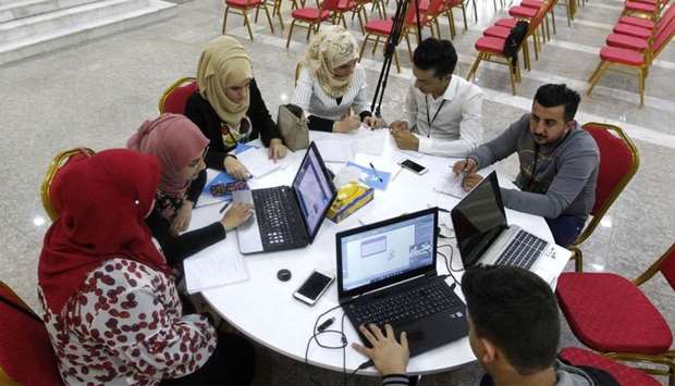 Iraqi youths work at ,The Station,, Baghdad's incubator for would-be entrepreneurs in Baghdad