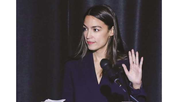 Alexandria Ocasio-Cortez takes the oath of office during her official swearing-in ceremony in Bronx, New York, on Saturday.