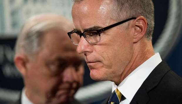 In this file photo taken on July 13, 2017 US Attorney General Jeff Sessions (L) looks on as Acting Director of the Federal Bureau of Investigation (FBI) Andrew McCabe (R) speaks during a press conference at the US Department of Justice in Washington, DC.