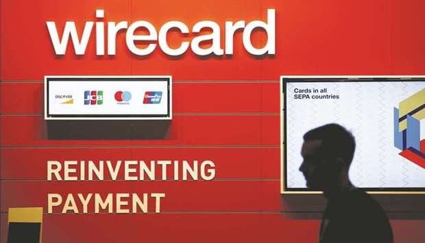 A man walks past the Wirecard booth at the computer games fair Gamescom in Cologne, Germany (file). Germanyu2019s financial watchdog has banned u201cshortu201d selling of Wirecard shares due to volatility in the payments firmu2019s stock following reports in the Financial Times which are now the subject of an investigation by German authorities.