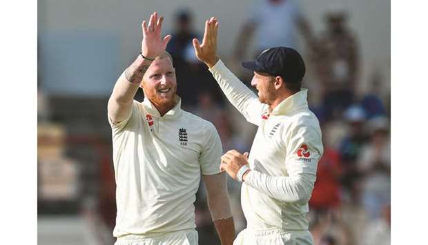 Ben Stokes (left) and Jos Buttler of England celebrate the dismissal of Shannon Gabriel of West Indies on the day four of the 3rd and final Test at Darren Sammy Cricket Ground, Gros Islet, Saint Lucia, on February 12, 2019. (AFP)