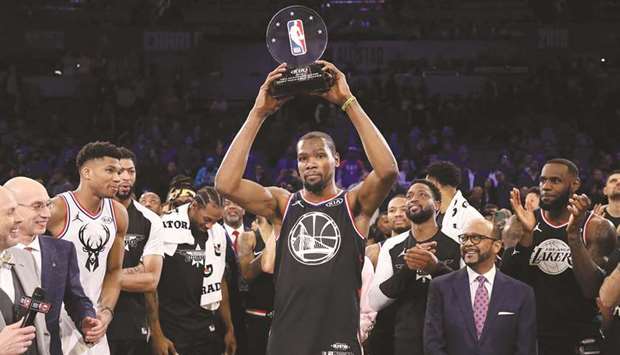 Kevin Durant of the Golden State Warriors and Team LeBron celebrates with the MVP trophy after their 178-164 win over Team Giannis during the NBA All-Star game as part of the 2019 NBA All-Star Weekend at Spectrum Center in Charlotte, North Carolina. (AFP)