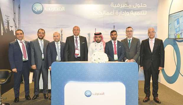 QIB Group CEO Bassel Gamal with banku2019s senior managers at the QIB stand at the  Tawteen event.