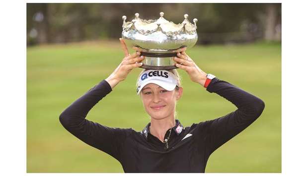 Nelly Korda of the US poses with the winneru2019s trophy following her victory on the final day of the womenu2019s LPGA Tour-sanctioned Australian Open golf championship at the Grange Golf Club in Adelaide on February 17.