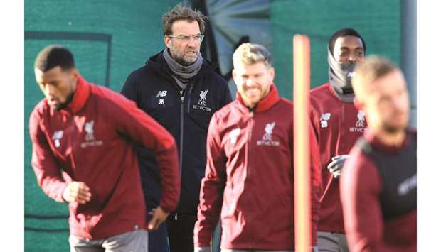 Liverpoolu2019s German manager Jurgen Klopp (second left) attends a team training session at Melwood in Liverpool, north west England yesterday, on the eve of their Champions League round of 16, first leg match against Bayern Munich. (AFP)