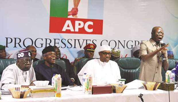 Nigerian President and All Progressives Congress (APC) candidate Muhammadu Buhari listens on as party chairman Adams Oshiomhole speak during the party caucus emergency meeting in Abuja yesterday.