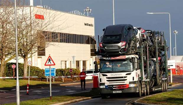 A lorry with car carrier trailer leaves the Honda car plant in Swindon, Britain