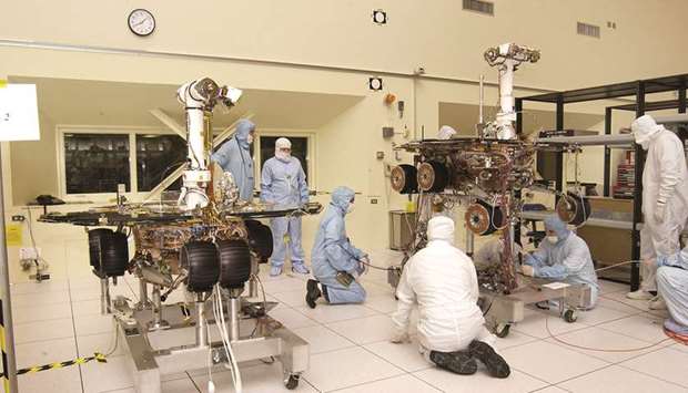 TWINS: JPL engineers make adjustments to Spirit. At left is its twin, Opportunity.