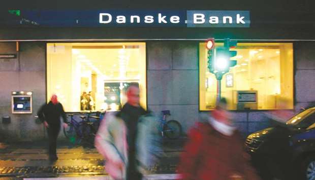 Residents walk past a Danske Bank branch in Copenhagen. The Financial Supervisory Authority in Tallinn took the extraordinary step yesterday of ordering Danske to close its operations in Estonia.