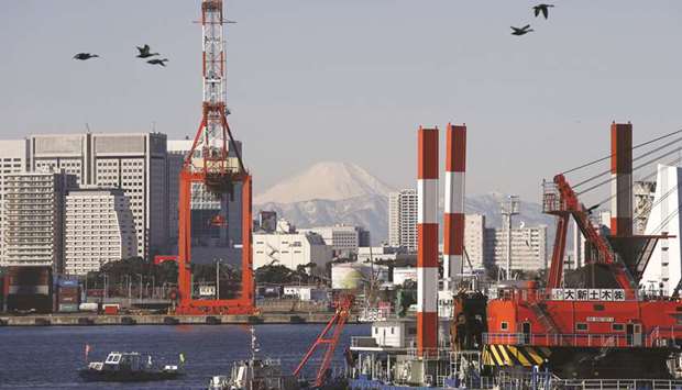 A crane is seen at a port in Tokyo. Japanese business sentiment worsened in February to levels last seen in late 2016, the Reuters Tankan poll showed, in a sign companies took a hit from weakening demand both at home and abroad in the face of slowing global growth and trade friction.