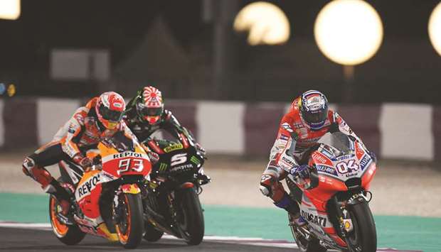 In this March 18, 2018, picture, Ducatiu2019s Andrea Dovizioso (right), Repsol Hondau2019s Marc Marquez (left) and Monster Yamaha Tech 3u2019s Johann Zarco ride around the Losail International Circuit during the MotoGP race at Grand Prix of Qatar.