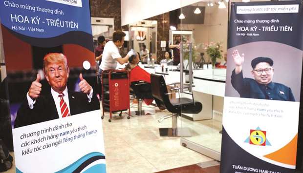 A barbershop offers free haircuts in the style of North Korean leader Kim Jong-un and US President Donald Trump in Hanoi yesterday.