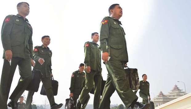 Military officers who are appointed members of the Myanmar Parliament arrive to attend a session in Naypyidaw yesterday.