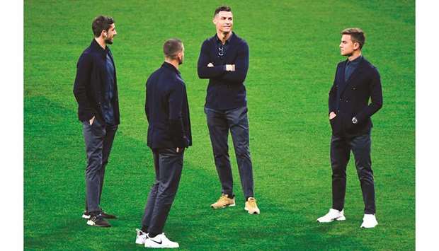 Juventusu2019 Cristiano Ronaldo (centre) and Paulo Dybala (right) talk to their teammates at the Wanda Metropolitan stadium in Madrid yesterday, ahead of their UEFA Champions League round of 16 first leg match against Atletico Madrid. (AFP)