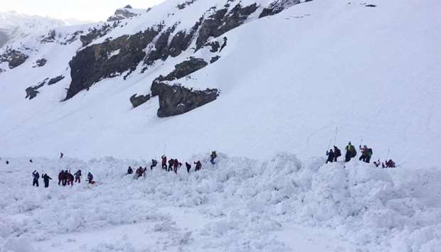 Rescuers on the site of a avalanche that left four skiers injured above the ski resort of Crans-Montana in the Swiss Alps