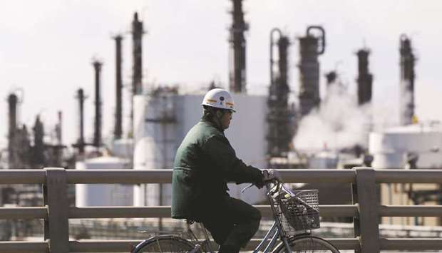 A worker cycles near a factory at the Keihin industrial zone in Kawasaki. Business investment in Japan has been a rare bright spot in the worldu2019s third-largest economy but that may now be fading amid anxiety over an upcoming sales tax hike and global trade frictions, a Reuters monthly corporate survey showed.