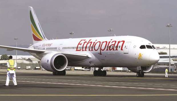A member of the ground crew directs an Ethiopian Airlines plane at the Bole International Airport in Ethiopiau2019s capital Addis Ababa (file). Weak infrastructure, high ticket prices, poor connectivity and lack of proper liberalisation are some of the headwinds on African aviationu2019s path, albeit the continent currently sees an economic boom with tourism benefiting from greater prosperity.
