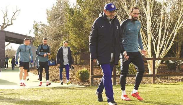 Chelsea manager Maurizio Sarri and forward Gonzalo Higuain (right) arrive for a training session yesterday at Cobham Training Centre in Cobham, Britain, ahead of their Europa League match against Malmo. (Reuters)