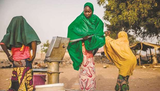 Camp dwellers pump water from a well at Malkohi refugee camp in Jimeta, Adamawa State, Nigeria.