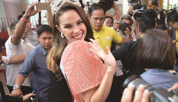 Miss Universe 2018 Catriona Gray of the Philippines waves to fans as she arrives for a press conference in Manila, yesterday.