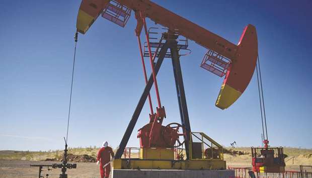 A PetroChina worker inspects a pump jack at an oil field in Tacheng,  Xinjiang. Royal Dutch Shell and PetroChina are at loggerheads over gas sales pricing at their Arrow Energy joint venture, holding up development of Australiau2019s biggest coal seam gas resource, three industry sources said.