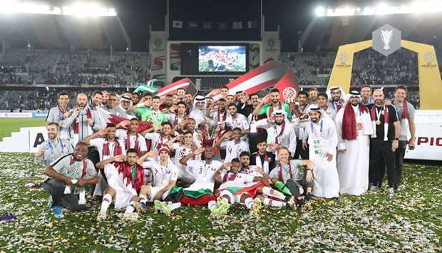 Qatar players pose with the trophy after winning the Asian Cup in Abu Dhabi yesterday. (Reuters)