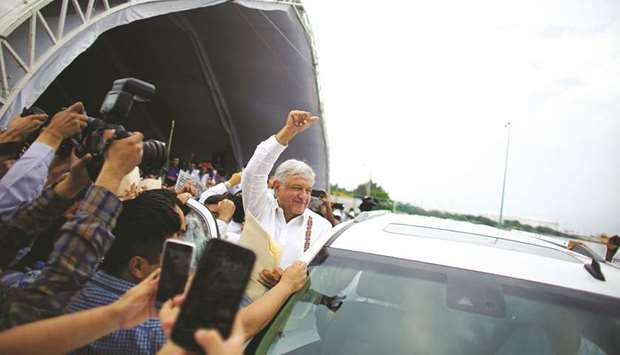 President Andres Manuel Lopez Obrador waves to supporters after an event to unveil his plan for oil refining in Paraiso, Tabasco state, in this December 9, 2018 file photo.