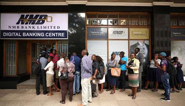 People queue outside a bank in Harare, Zimbabwe