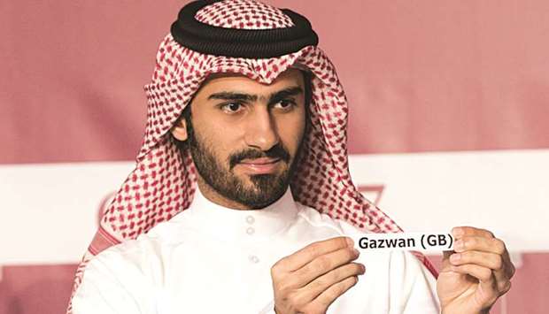 Jassim Mohamed al-Emadi picks Gazwan, owned by His Highness Sheikh Mohamed bin Khalifa al-Thani, from the pot during the draw ceremony yesterday. Gazwan will start HH The Amiru2019s Sword (Gr1 PA) from stall 6 tomorrow.