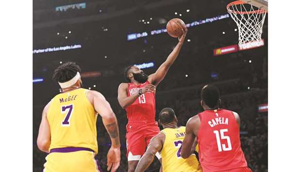 James Harden (second from left) of the Houston Rockets scores on a layup during the NBA game against the Los Angeles Lakers at in Los Angeles on Thursday. (AFP)