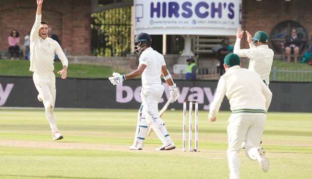 South African players celebrate the dismissal of Sri Lankau2019s Dimuth Karunaratne (C) during the second day of the second Test match in Port Elizabeth yesterday.
