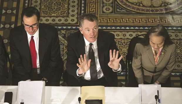 Robert Lighthizer, US trade representative (centre), signals to an aide as Steven Mnuchin, US Treasury secretary (left), listens during trade talks between the US and China in the Eisenhower Executive Office Building in Washington, DC, on Thursday. If the two sides fail to reach an agreement by March 1, US tariffs on $200bn worth of Chinese imports are set to rise to 25% from 10%.