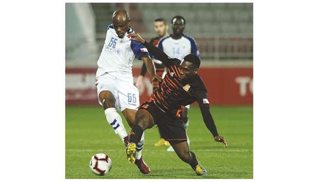 Umm Salal (in white) and Al Kharaitiyat players vie for the ball during the QNB Stars League match at the Al Duhail Stadium.