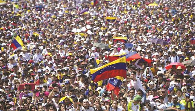People wait for the start of u201cVenezuela Aid Liveu201d concert, organised by British billionaire Richard Branson to raise money for the Venezuelan relief effort at Tienditas International Bridge in Cucuta, Colombia, yesterday.