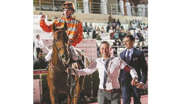 Trainer Jerome Reynier (right) is all smiles as Marianafoot enters the winneru2019s circle after Pierre-Charles Boudot (left) rode him to victory in the Irish Thoroughbred Marketing Cup (Group 2) yesterday.