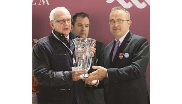 Irish ambassador Aidan Cronin (right) presents the owneru2019s trophy to Jean-Claude Seroul after Marianafoot won the Irish Thoroughbred Marketing Cup (Group 2) at the Qatar Racing and Equestrian Clubu2019s Al Rayyan Park yesterday. PICTURES: Juhaim
