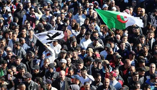 People march to protest against President Abdelaziz Bouteflika's plan to seek a fifth term in Algiers