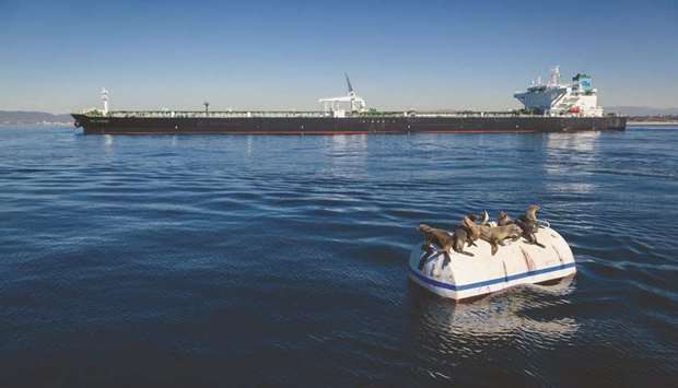 Seal lions sit on a mooring can as a crude oil tanker sits near the El Segundo Offshore Oil Terminal in El Segundo, California (file). Shippers are counting on the US exports to help the tanker market withstand supply restrictions by Opec and allies including Russia.